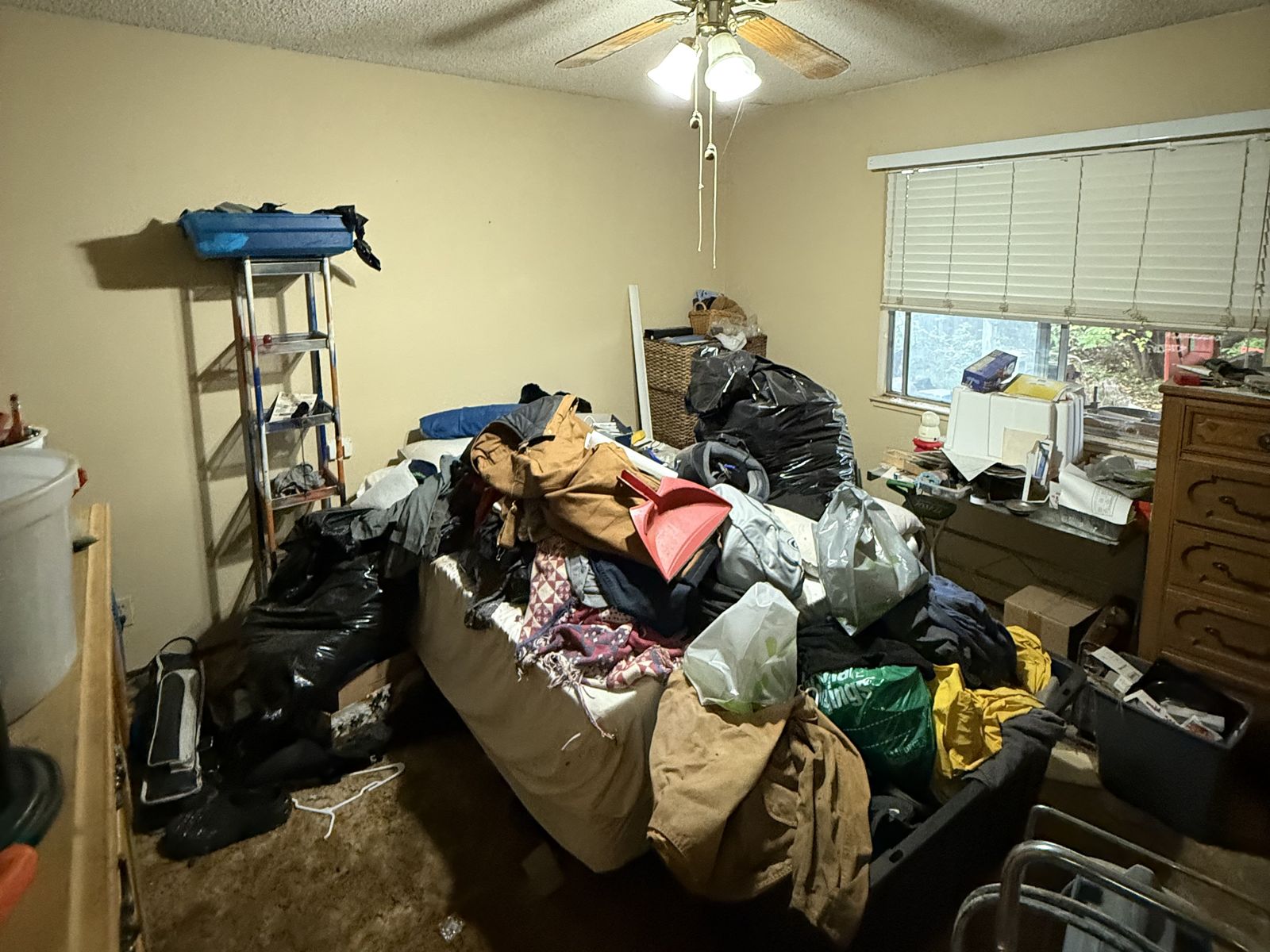Derek Drive bedroom still piled with belongings — listed exactly like this