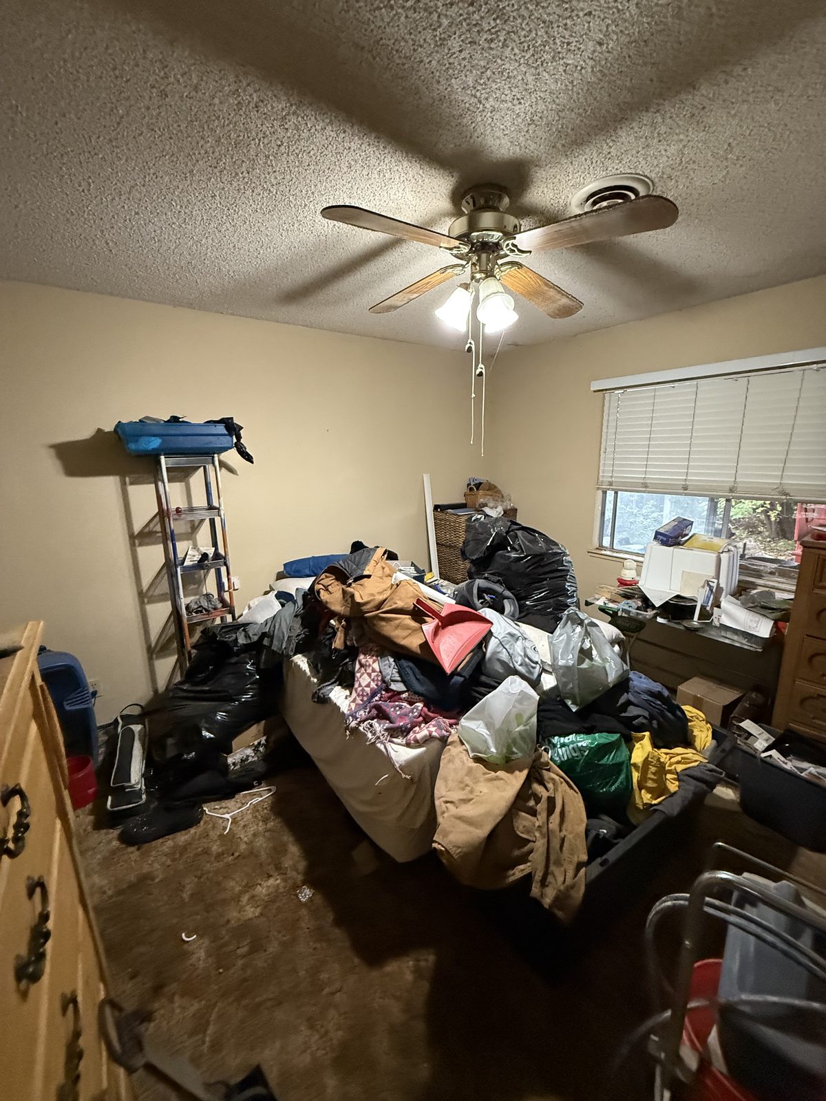 Local probate home listed as-is by Yuba Sutter Real Estate Group — packed bedroom