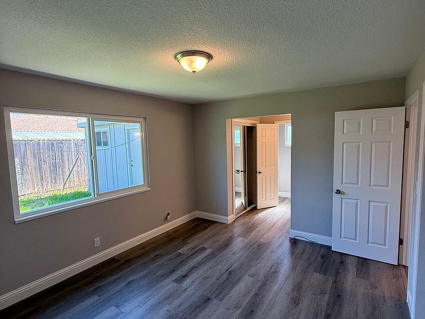 1203 Woodworth Ave, Yuba City — refinished bedroom with new flooring by Yuba Sutter Real Estate Group