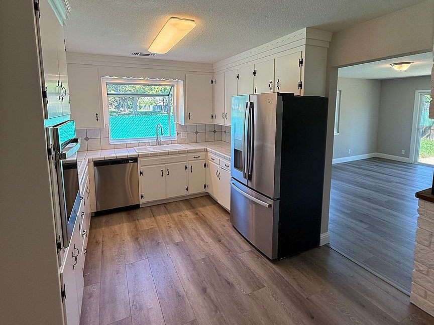 1203 Woodworth Ave, Yuba City — renovated kitchen with stainless appliances by Yuba Sutter Real Estate Group