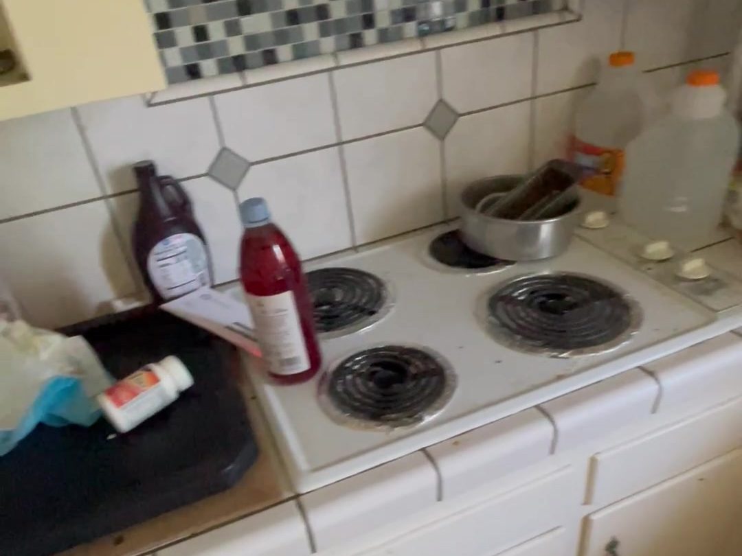 1203 Woodworth Ave, Yuba City — kitchen before renovation, still full of belongings